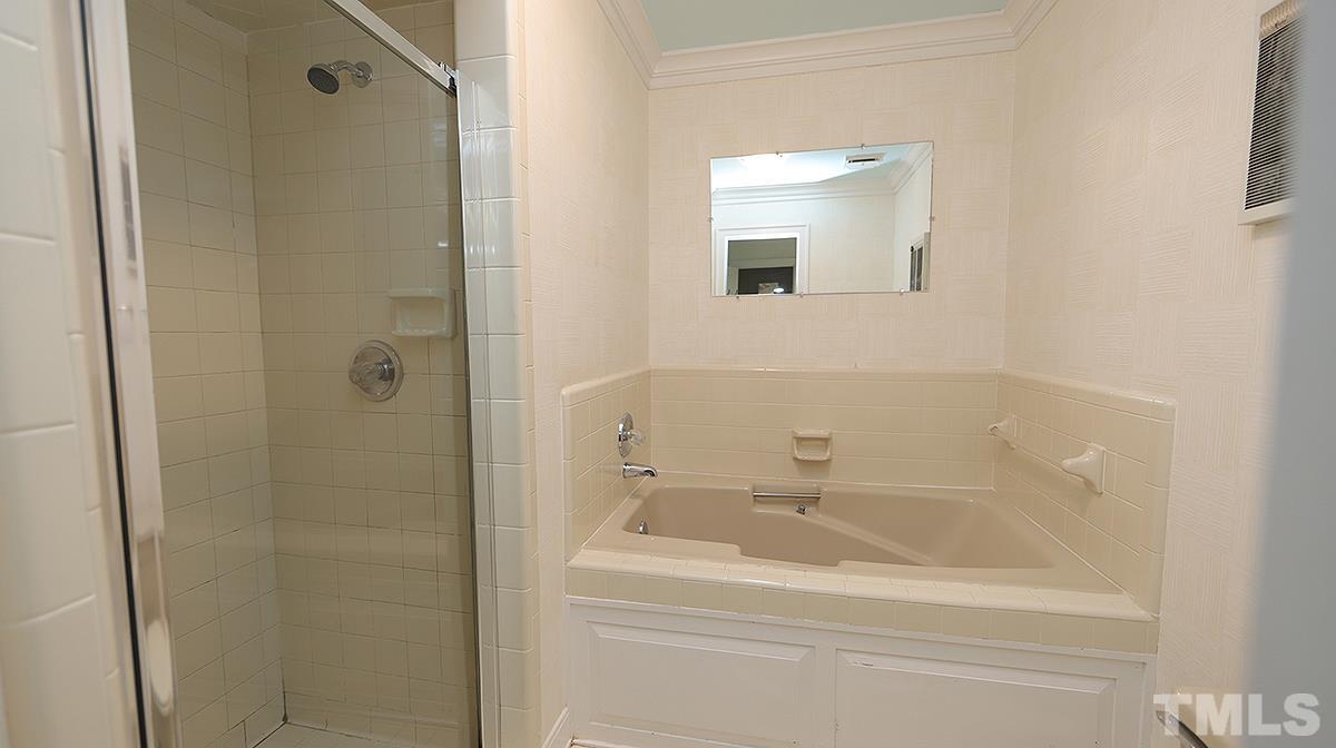 2203 Landings Way Raleigh, NC 27615 - Photo 16 of 22 a bathroom with a bathtub and a sink