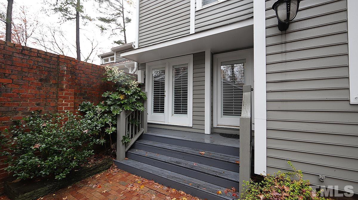 2203 Landings Way Raleigh, NC 27615 - Photo 2 of 22 a view of a house with a large window and flower plants