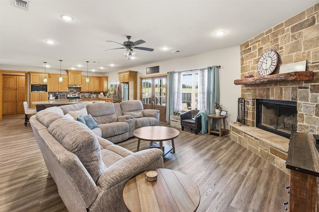 971 Bamboo Road Big Sandy, TX 75755 - Photo 12 of 40 a living room with furniture a fireplace and a large window