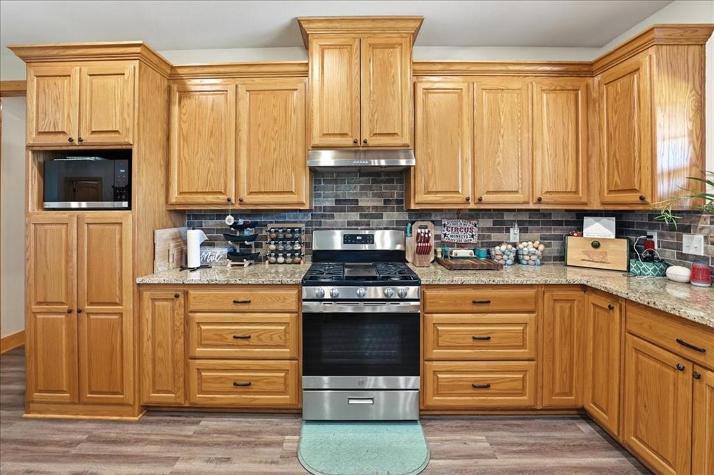 971 Bamboo Road Big Sandy, TX 75755 - Photo 15 of 40 a kitchen with stainless steel appliances granite countertop a stove and a refrigerator