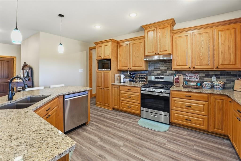 971 Bamboo Road Big Sandy, TX 75755 - Photo 16 of 40 a kitchen with stainless steel appliances granite countertop a stove a sink and a refrigerator