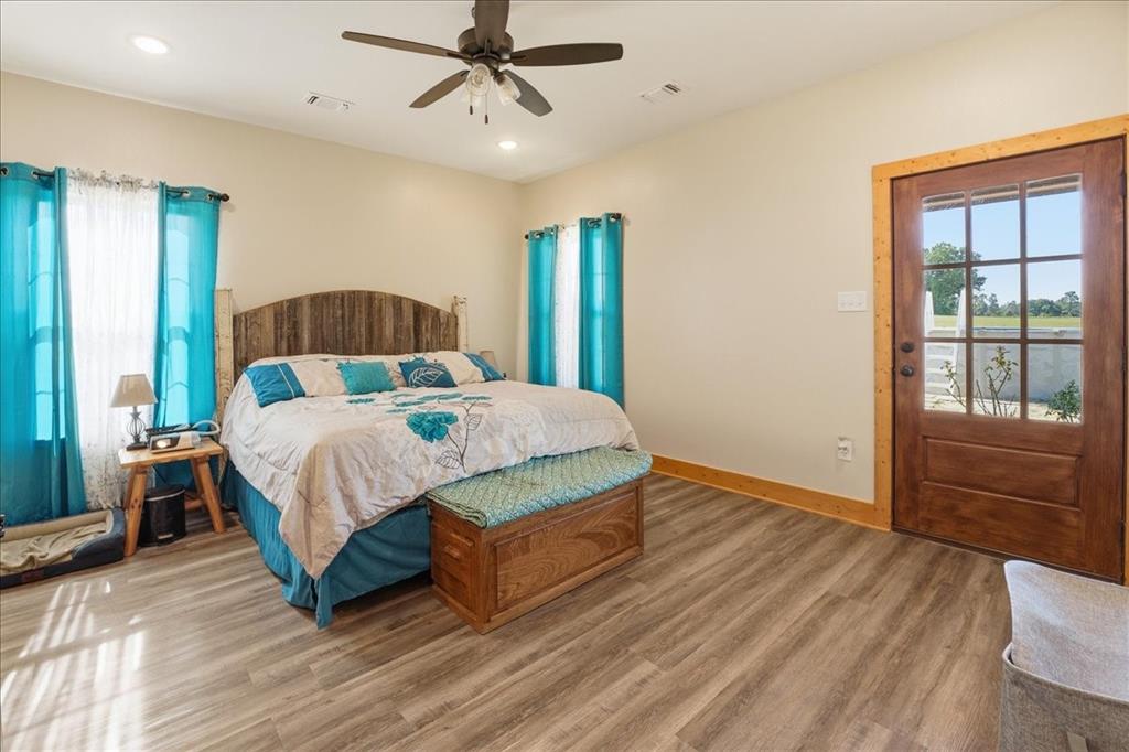 971 Bamboo Road Big Sandy, TX 75755 - Photo 18 of 40 a bedroom with a large bed and a chandelier