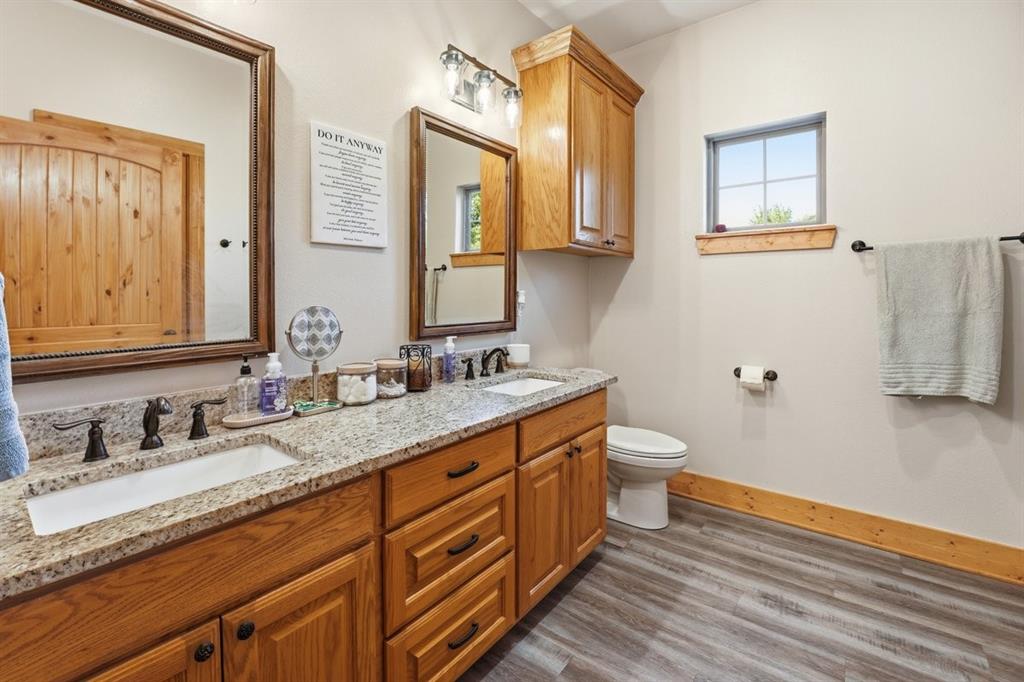 971 Bamboo Road Big Sandy, TX 75755 - Photo 23 of 40 a bathroom with a double vanity sink and a mirror
