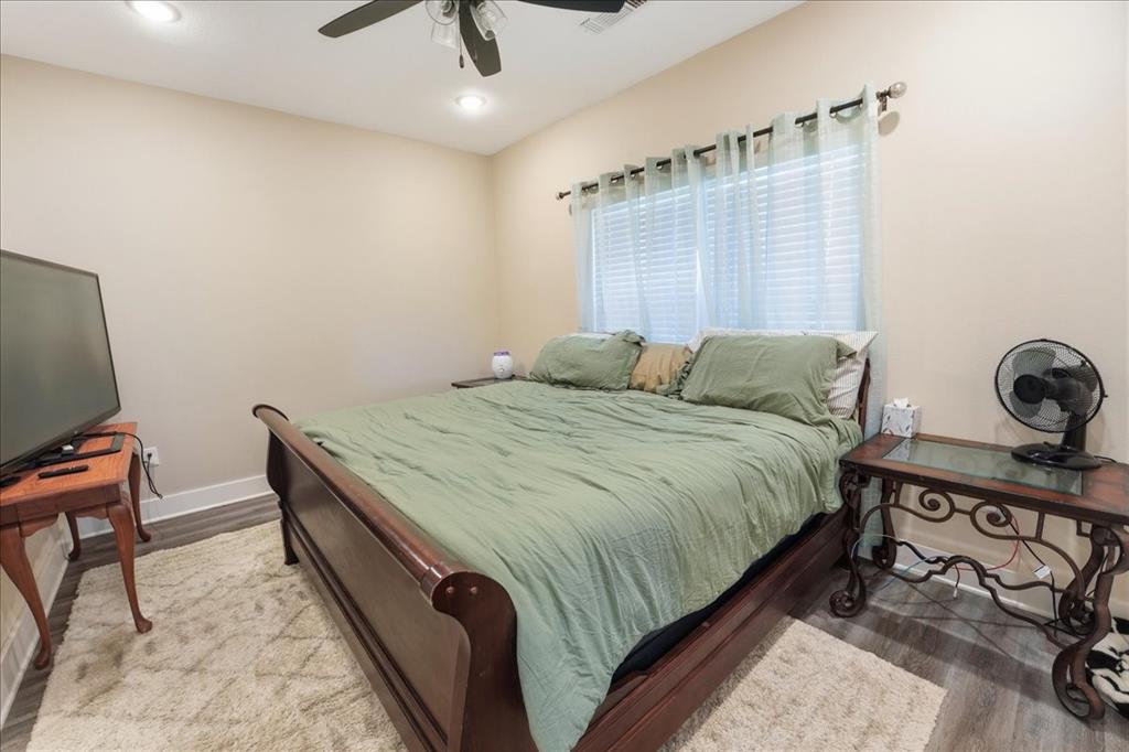 971 Bamboo Road Big Sandy, TX 75755 - Photo 29 of 40 a bedroom with a bed and a chandelier