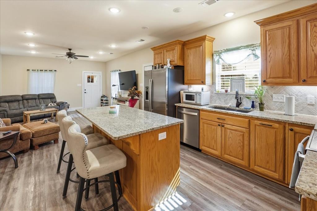 971 Bamboo Road Big Sandy, TX 75755 - Photo 30 of 40 a kitchen with granite countertop a sink stove and refrigerator