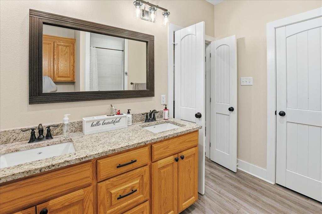 971 Bamboo Road Big Sandy, TX 75755 - Photo 32 of 40 a bathroom with a granite countertop double vanity sink and mirror