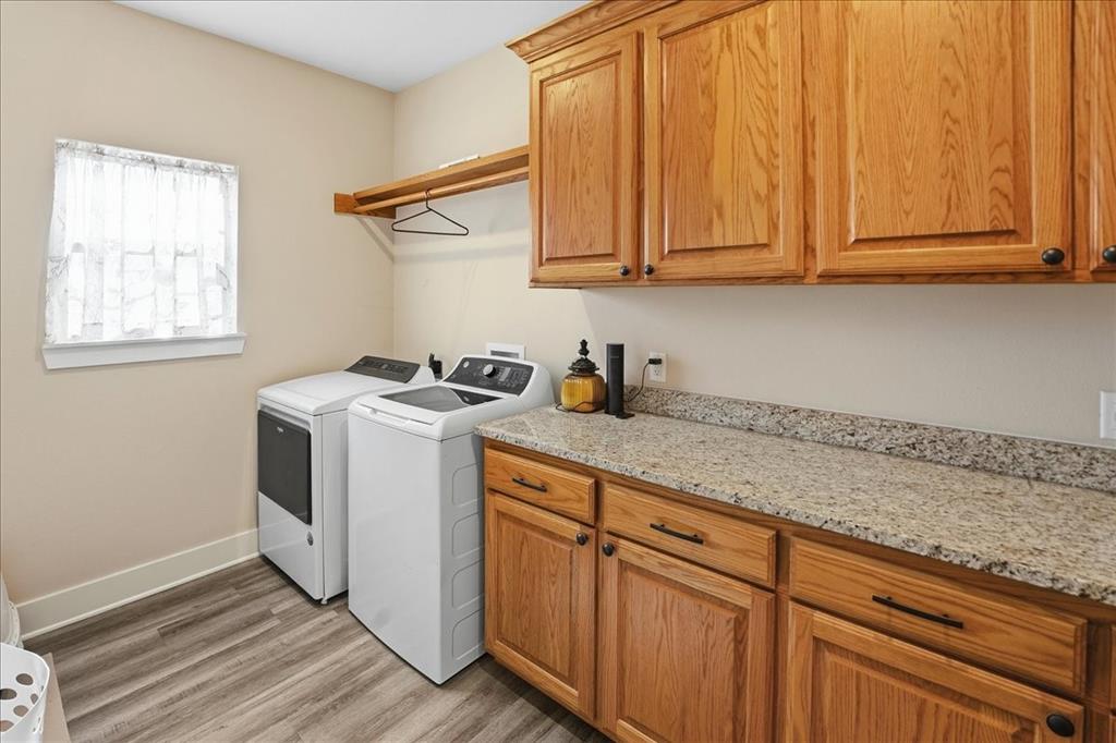 971 Bamboo Road Big Sandy, TX 75755 - Photo 35 of 40 a utility room with granite countertop cabinets washer and dryer
