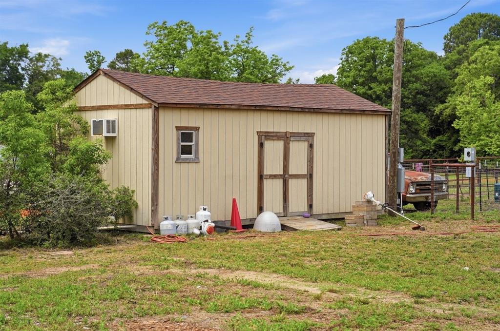 971 Bamboo Road Big Sandy, TX 75755 - Photo 39 of 40 a backyard of a house with table and chairs