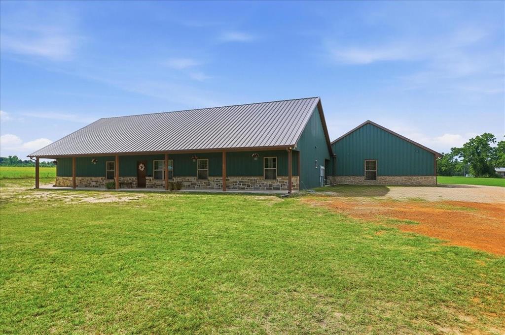 971 Bamboo Road Big Sandy, TX 75755 - Photo 4 of 40 a front view of house with yard slide and large trees