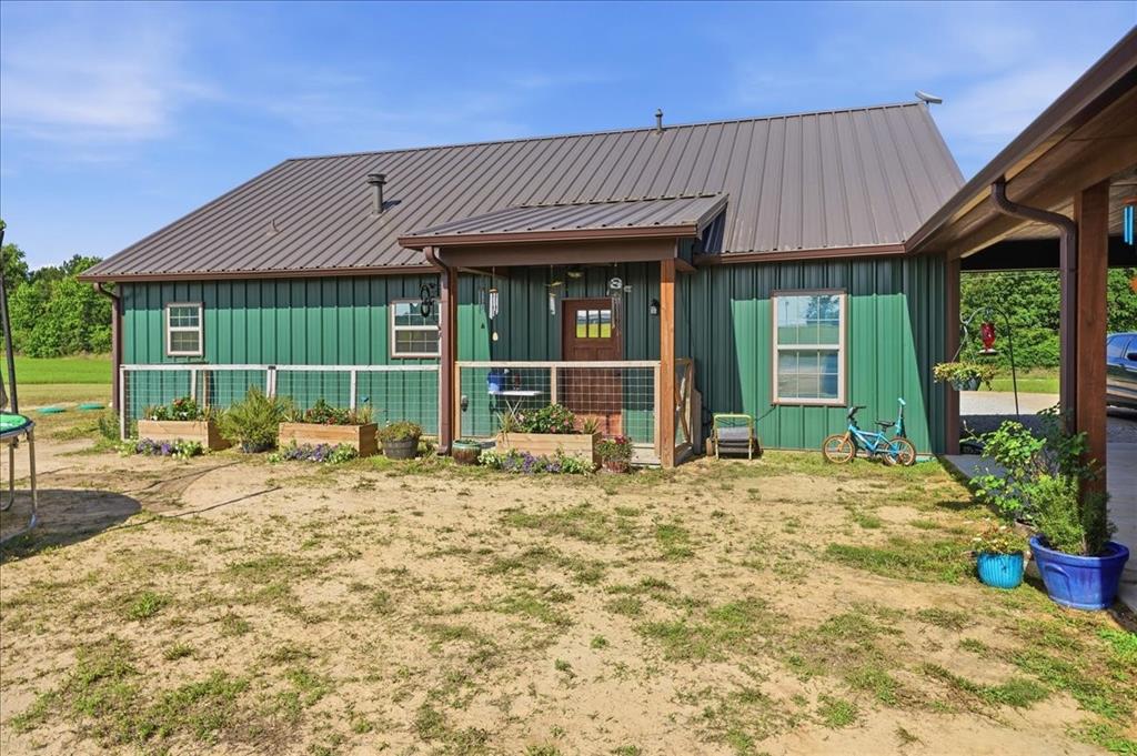 971 Bamboo Road Big Sandy, TX 75755 - Photo 6 of 40 a view of a house with large windows and plants