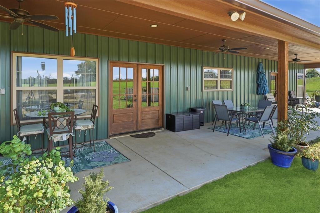 971 Bamboo Road Big Sandy, TX 75755 - Photo 7 of 40 a view of a porch with chairs and potted plants