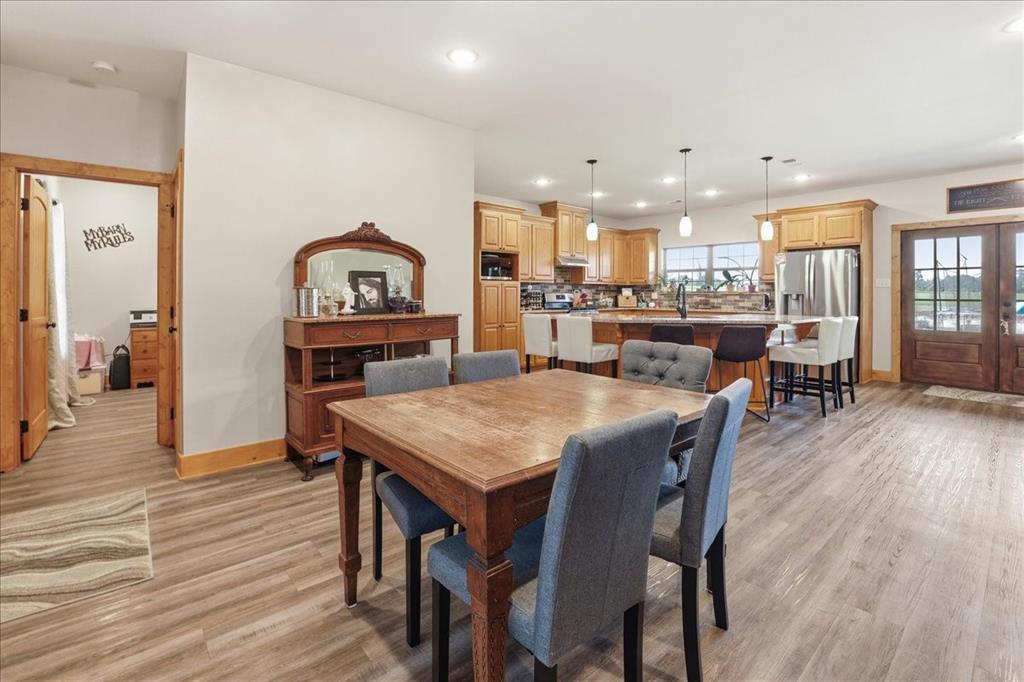 971 Bamboo Road Big Sandy, TX 75755 - Photo 10 of 40 a view of a dining room with furniture and wooden floor