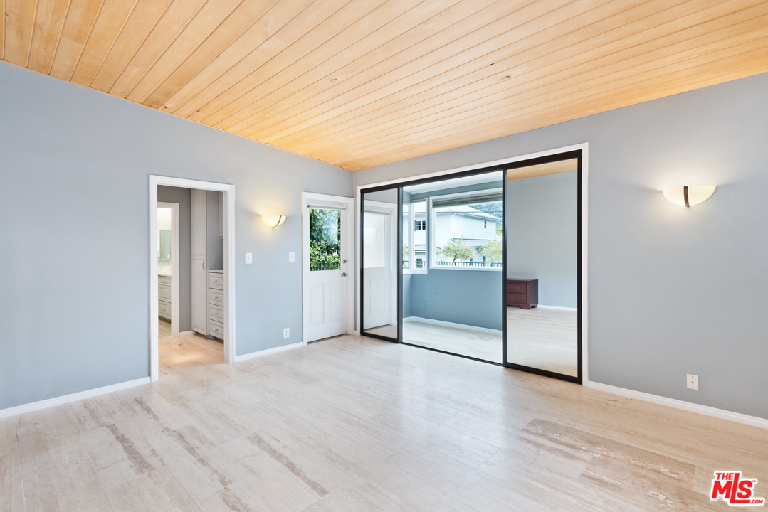 9614 Heather Road Beverly Hills, CA 90210 - Photo 13 of 26 a view of a livingroom with wooden floor and cabinet