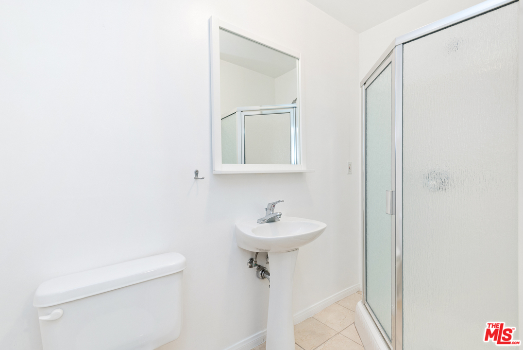 9614 Heather Road Beverly Hills, CA 90210 - Photo 21 of 26 a bathroom with a sink a toilet and shower