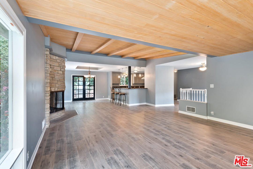 9614 Heather Road Beverly Hills, CA 90210 - Photo 3 of 26 a view of an empty room with wooden floor and a window