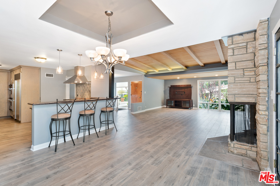 9614 Heather Road Beverly Hills, CA 90210 - Photo 4 of 26 a view of a dining room with furniture and wooden floor