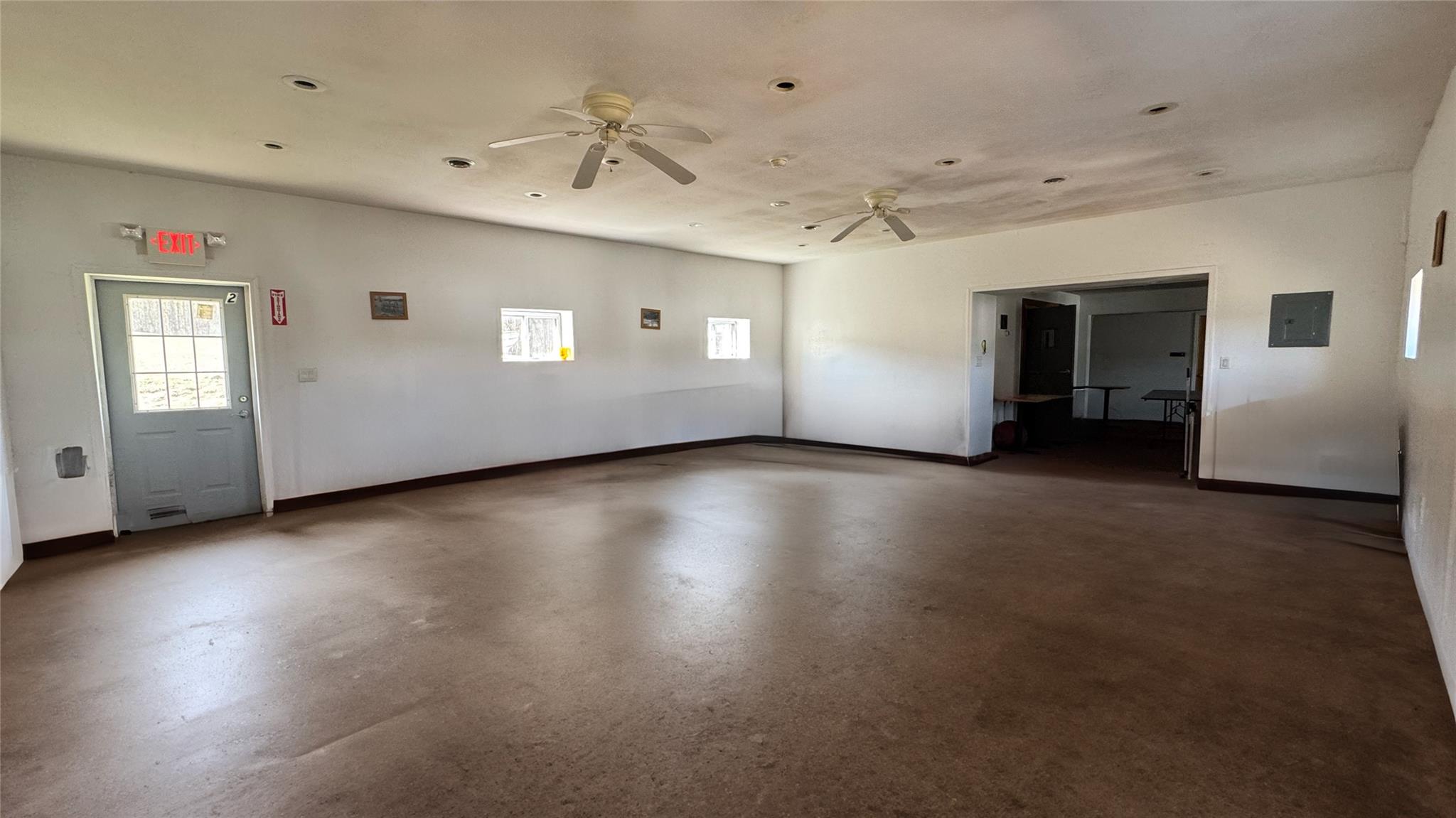 892 Bowbell Road Greene, NY 13778 - Photo 17 of 35 Empty room with concrete floors, a ceiling fan, and electric panel