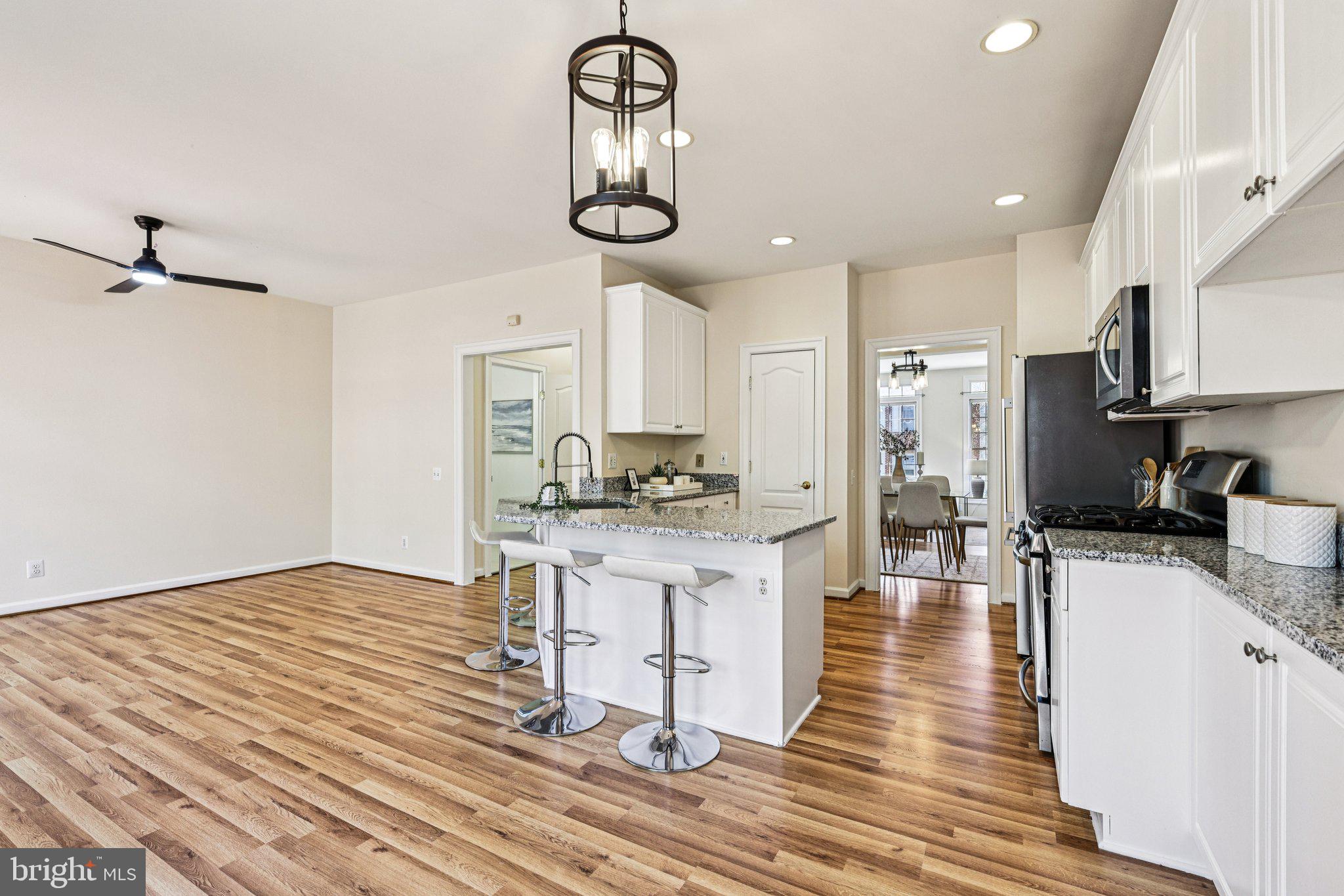 2746 Pembsly Drive Vienna, VA 22181 - Photo 13 of 46 a kitchen with stainless steel appliances a dining table chairs stove and cabinets