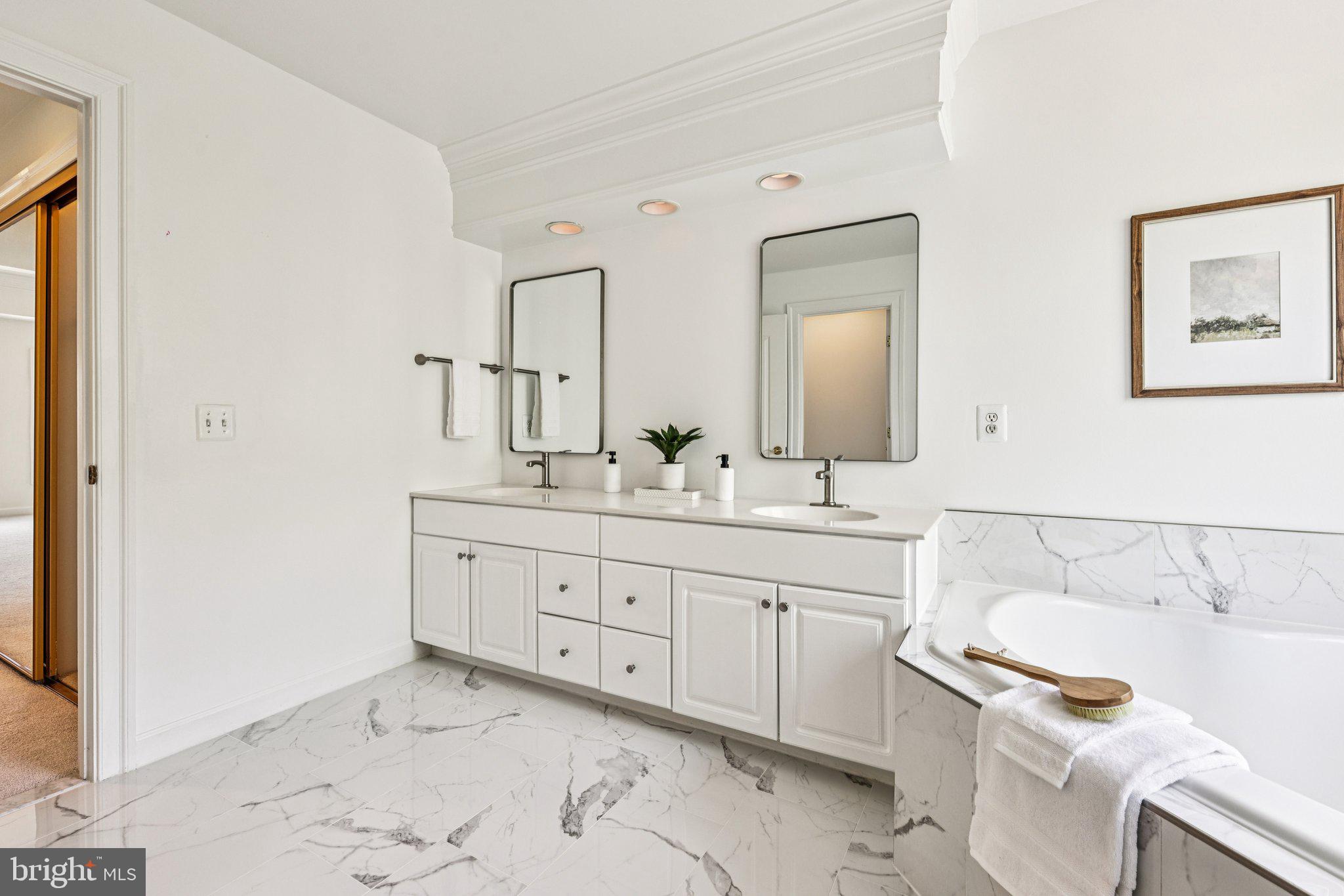 2746 Pembsly Drive Vienna, VA 22181 - Photo 21 of 46 a spacious bathroom with a double vanity sink a mirror and a