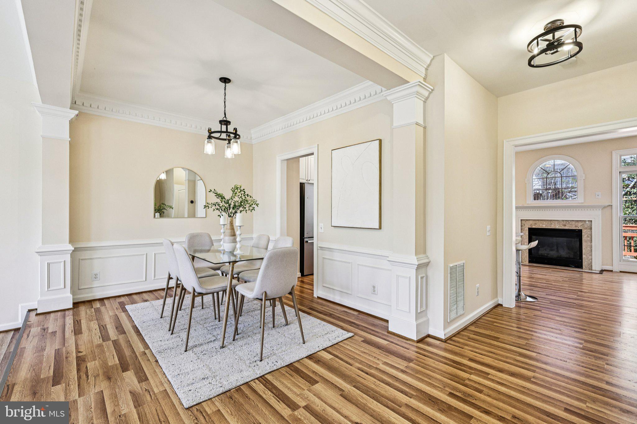2746 Pembsly Drive Vienna, VA 22181 - Photo 8 of 46 a dining room with wooden floor a chandelier a wooden table and chairs