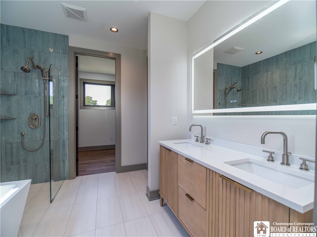 3034 Mandolin Rdg Way Chautauqua, NY 14757 - Photo 15 of 31 The exceptional spa-like en-suite features a doubl