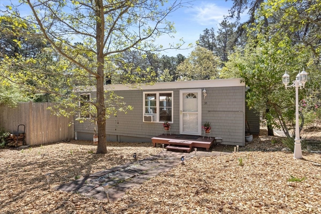 35 Tecumseh Road Wellfleet, MA 02667 - Photo 5 of 24 a backyard of a house with barbeque oven