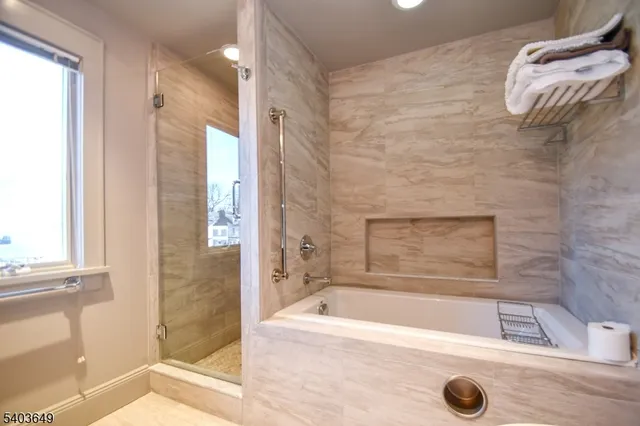 a bathroom with a tub and a shower