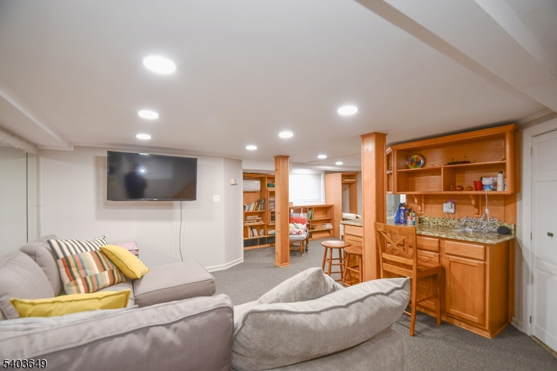 11 Morris Court Summit, NJ 07901 - Photo 15 of 16 a living room with furniture and a flat screen tv