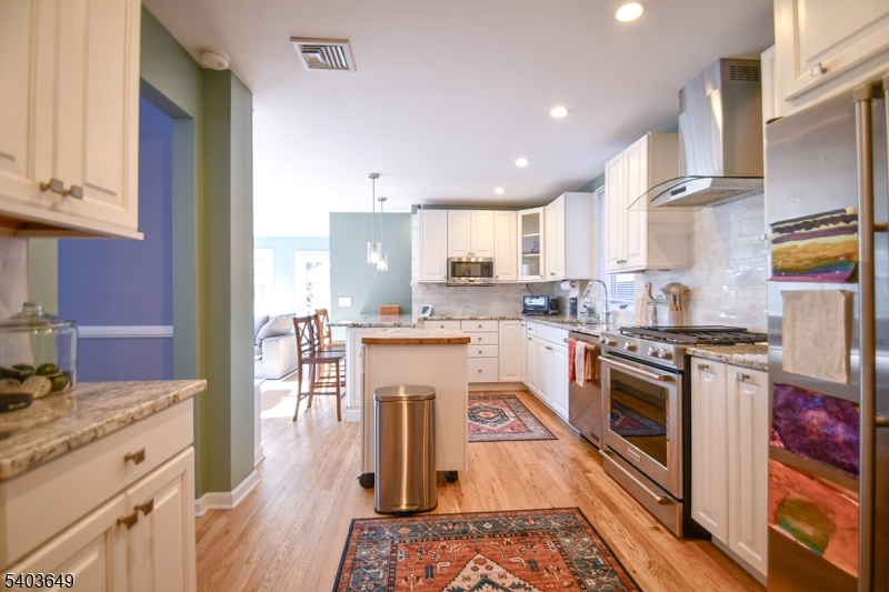 11 Morris Court Summit, NJ 07901 - Photo 5 of 16 a kitchen with a stove sink cabinets and wooden floor