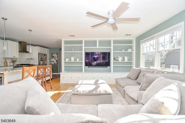 a living room with furniture and kitchen view