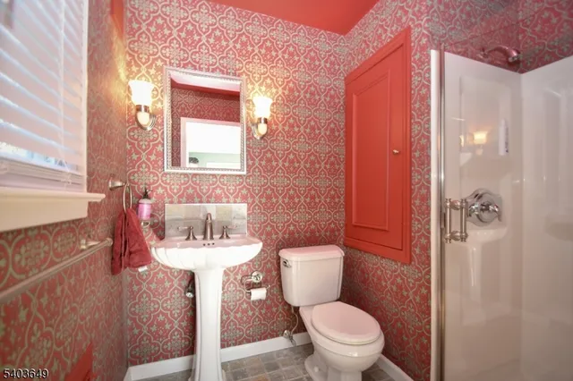 a bathroom with a sink toilet and a mirror