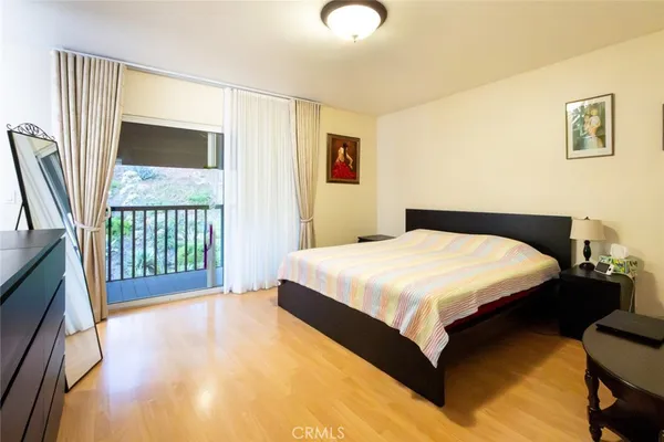 a spacious bedroom with a bed and a window