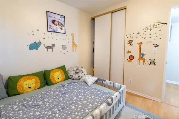 a bedroom with a bed and painting on the wall