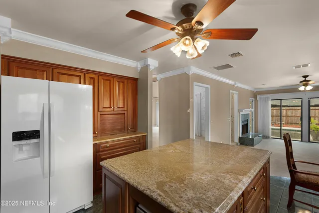 a kitchen with stainless steel appliances granite countertop cabinets and refrigerator