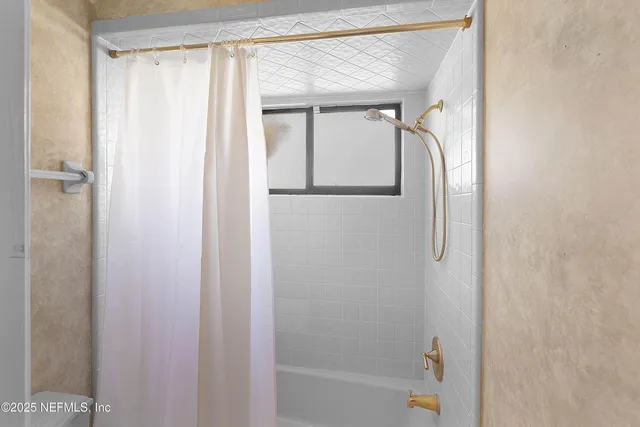 a bathroom with a glass shower door