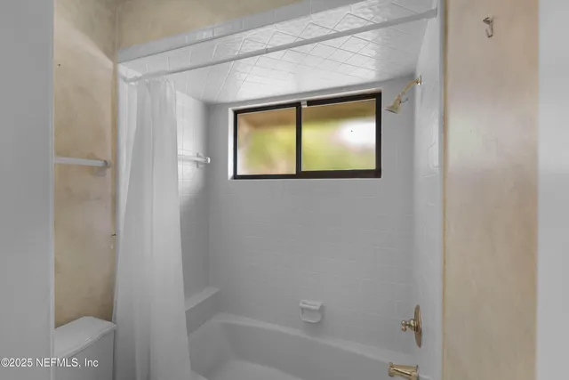 a bathroom with a bathtub and shower