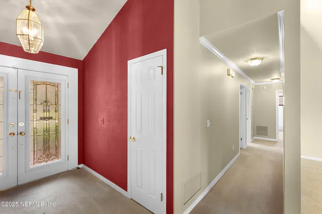 a view of hallway with bathroom