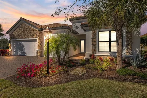 a view of a backyard with a patio and a yard