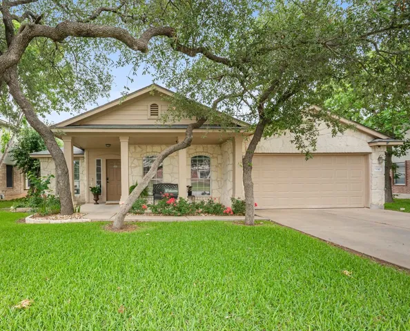 a view of a house with a yard and sitting area