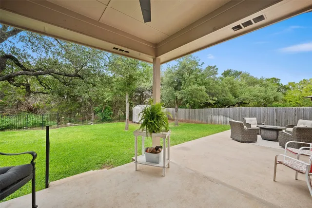 a view of a chair and table in the garden