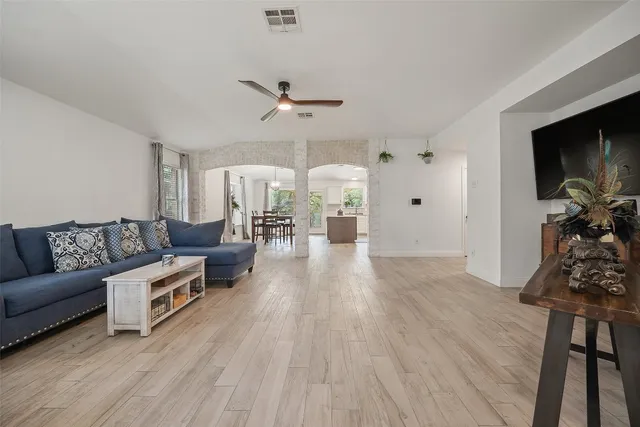 a large kitchen with a table and chairs