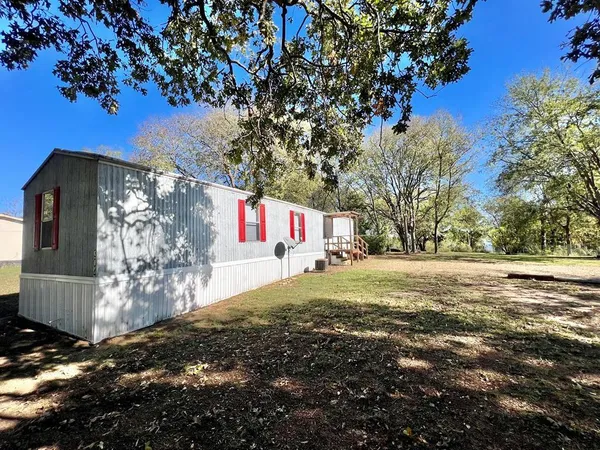 a view of a tree in front of a house