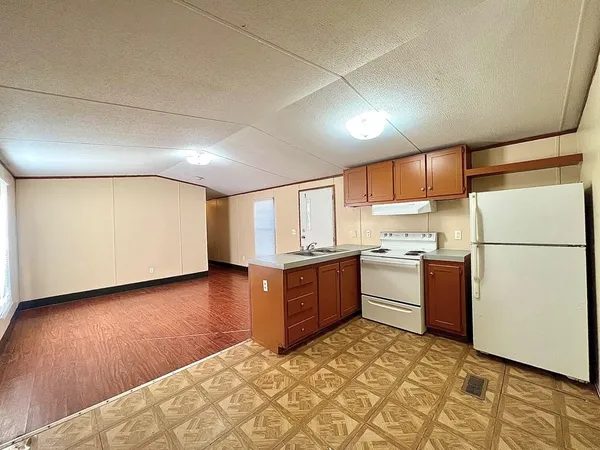 a kitchen with sink refrigerator and microwave