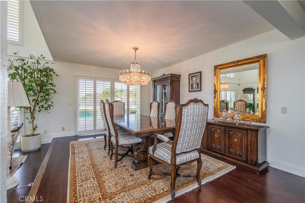 8213 Seranata Drive Whittier, CA 90603 - Photo 11 of 64 a view of a dining room with furniture a chandelier and wooden floor