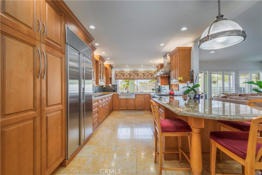 8213 Seranata Drive Whittier, CA 90603 - Photo 14 of 64 a kitchen with stainless steel appliances granite countertop counter space a sink and cabinets