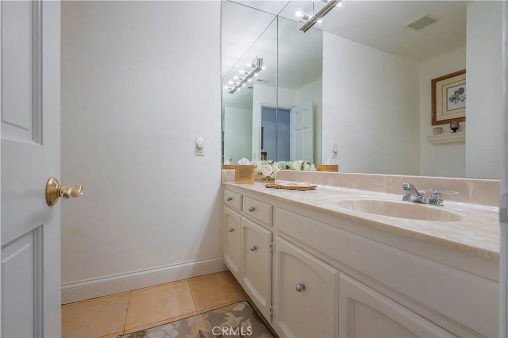 8213 Seranata Drive Whittier, CA 90603 - Photo 21 of 64 a bathroom with a double vanity sink and mirror
