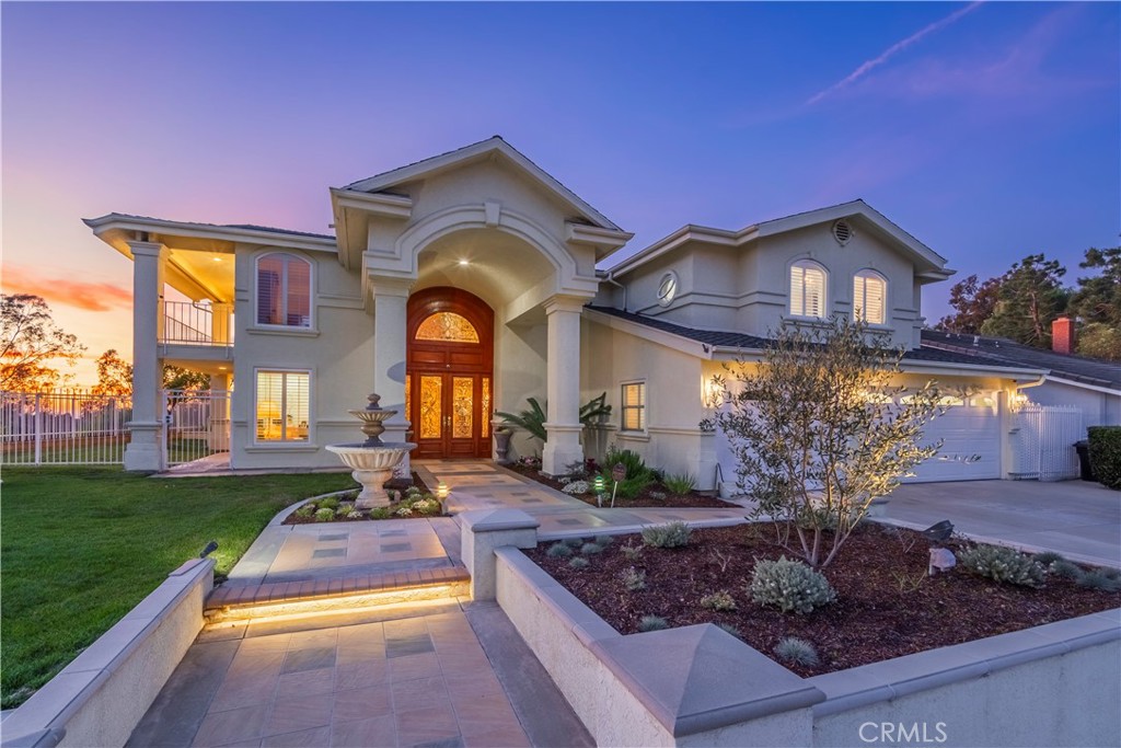 8213 Seranata Drive Whittier, CA 90603 - Photo 3 of 64 a front view of a house with garden