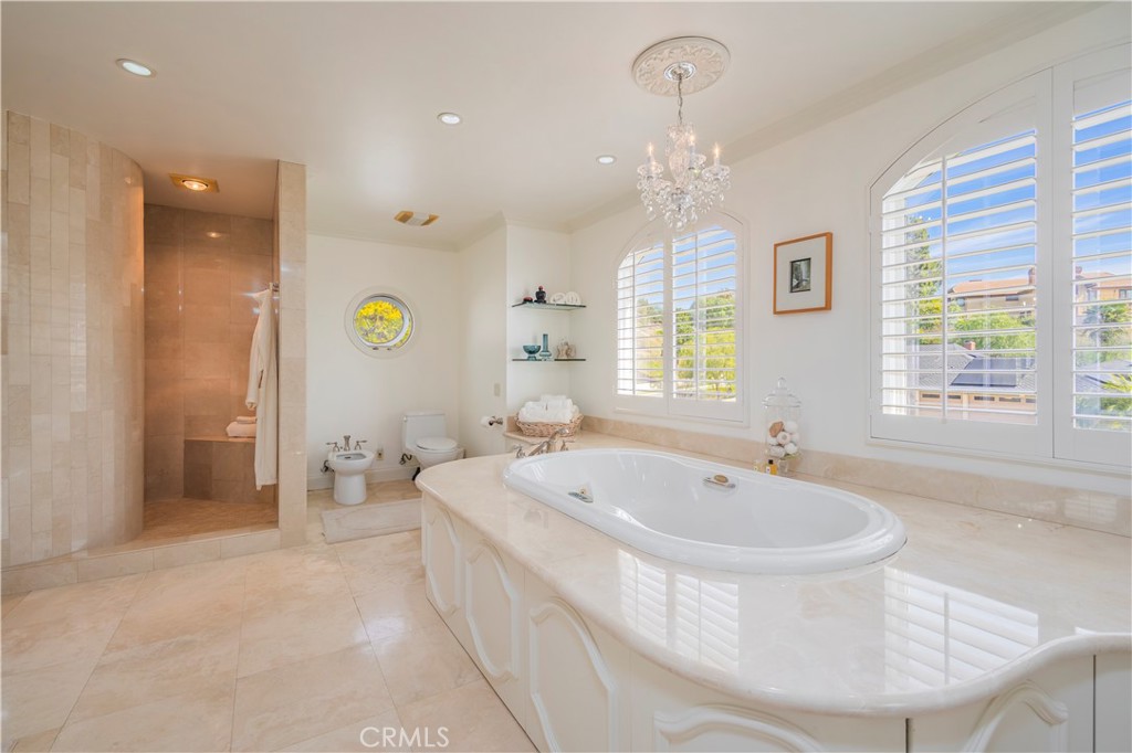 8213 Seranata Drive Whittier, CA 90603 - Photo 31 of 64 a spacious bathroom with a tub sink and mirror