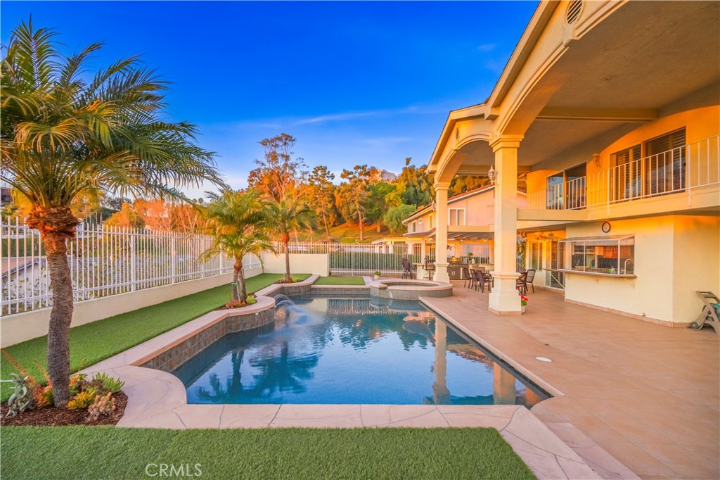 8213 Seranata Drive Whittier, CA 90603 - Photo 36 of 64 a view of a swimming pool with a lounge chairs