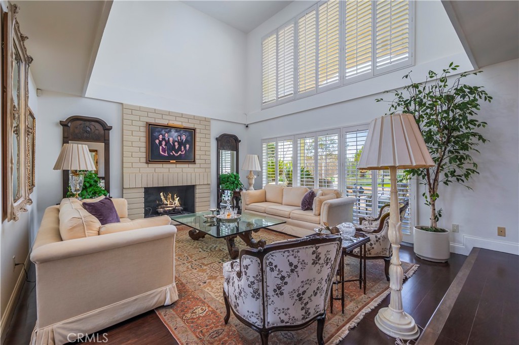 8213 Seranata Drive Whittier, CA 90603 - Photo 9 of 64 a living room with furniture a fireplace and a potted plant